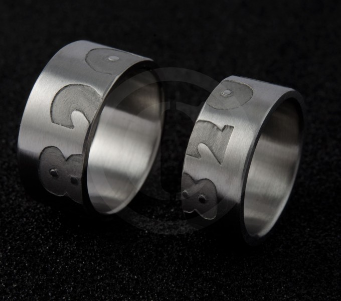 chrome cobalt wedding rings with engraved half on one ring and half on the the brides ring. 